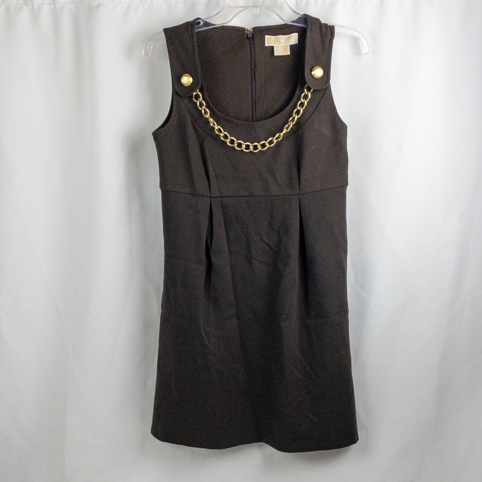 MICHAEL Michael Kors brown sleeveless dress with gold chain detail and back zipper closure on hanger