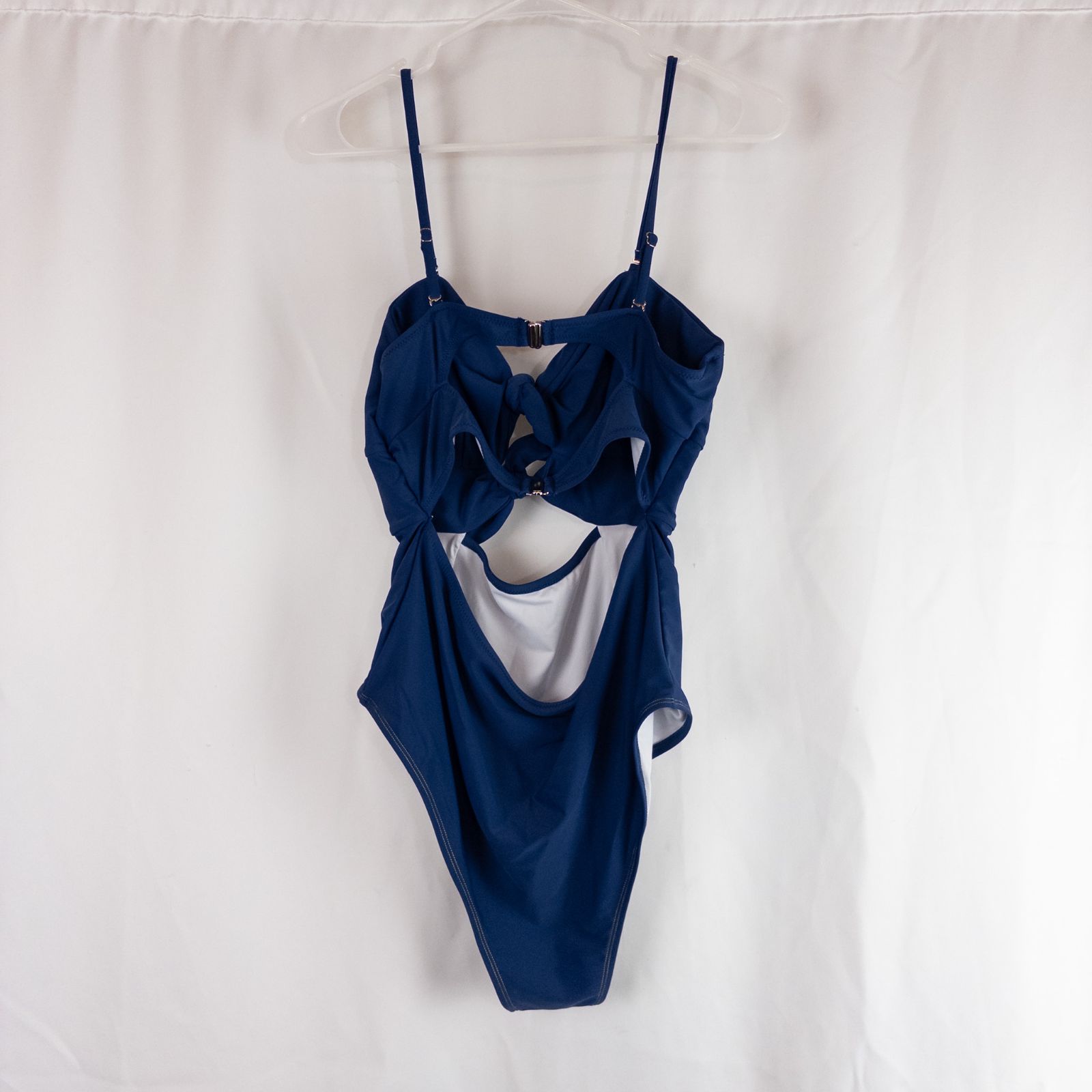 Blue Cupshe one piece swimsuit with cutout and knot detailing front view on hanger image 5
