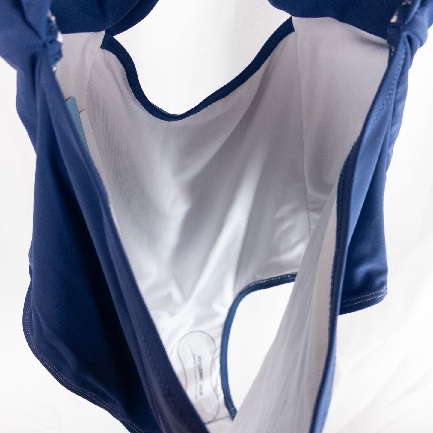 Blue Cupshe one piece swimsuit with cutout and knot detailing front view on hanger image 7