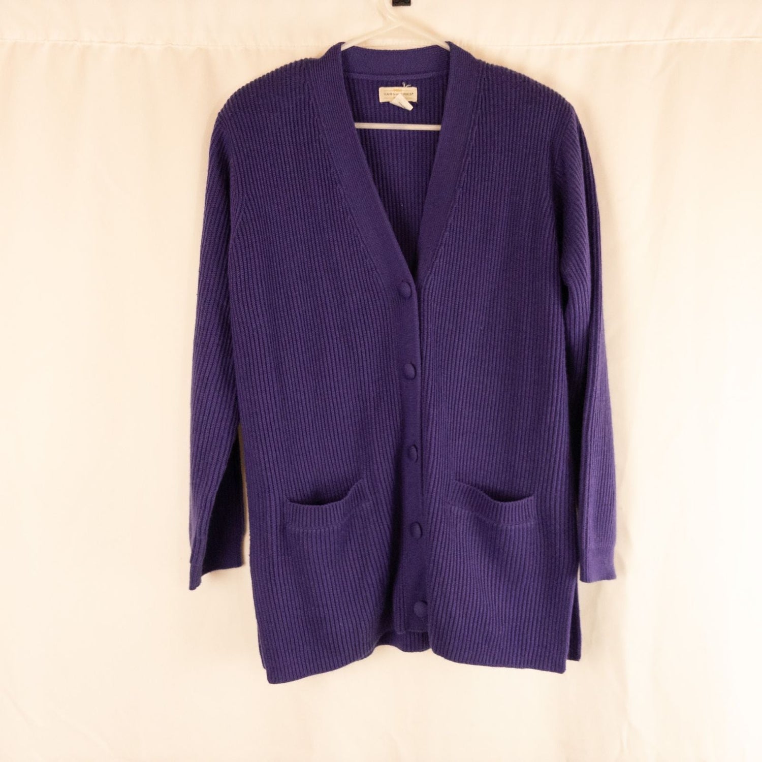 Vintage Yarnworks purple chunky knit cardigan with button front and two pockets hanging on hanger