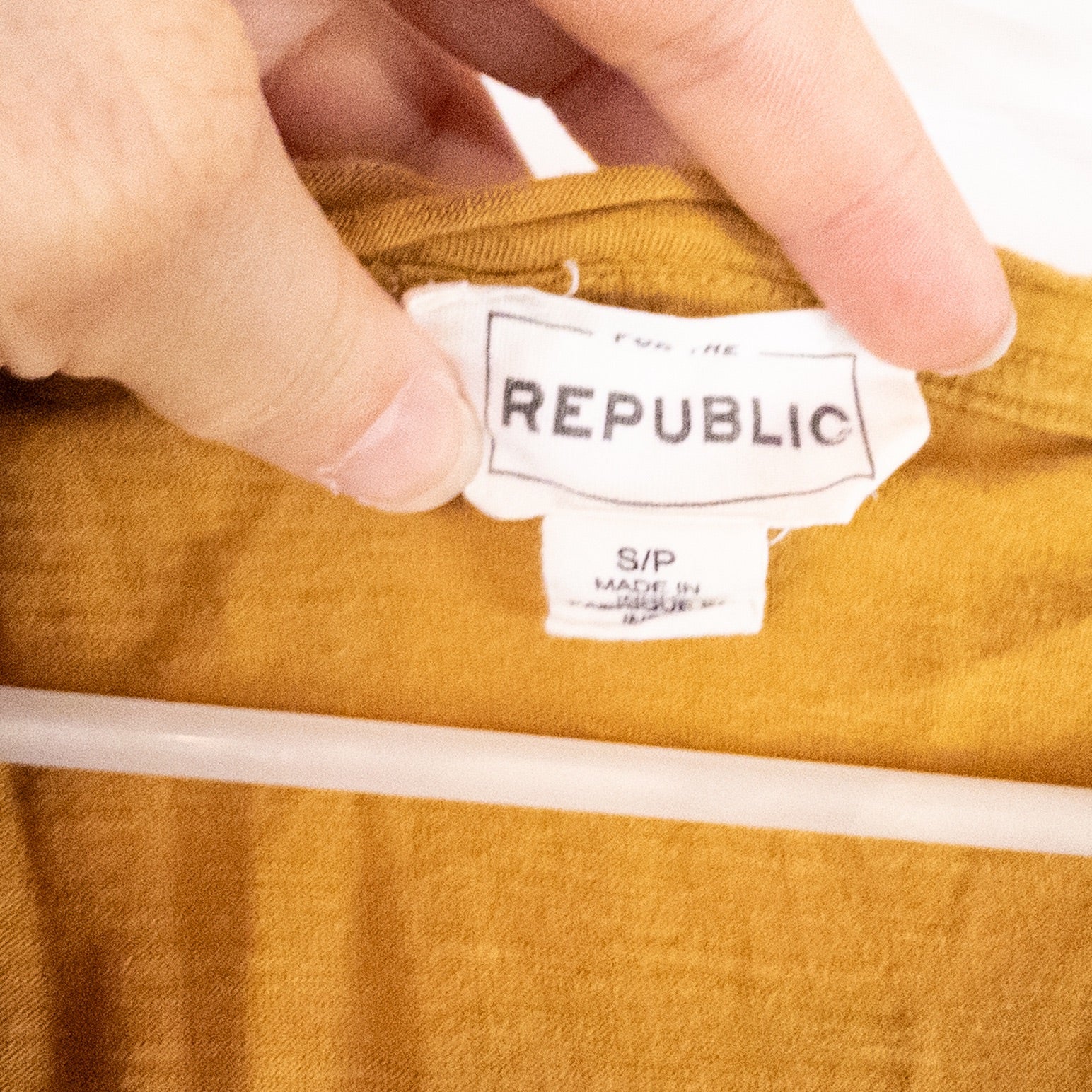 Republic brown scoop neck t-shirt with chest pocket hanging on a white hanger image 7