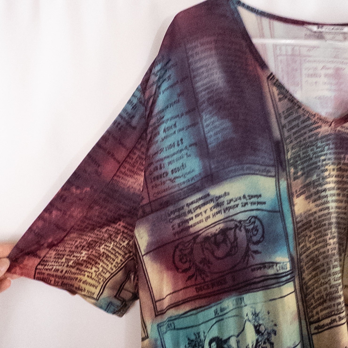 Nygard multicolor horoscope boho top with v-neck and short sleeves hanging on plastic hanger image 3