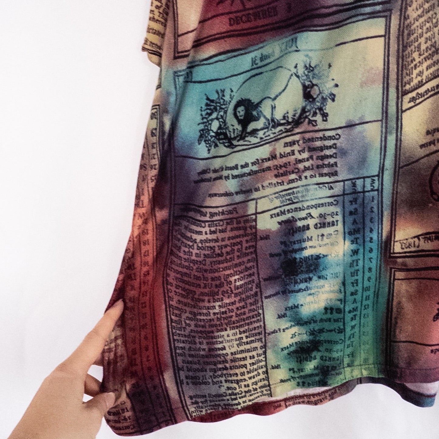 Nygard multicolor horoscope boho top with v-neck and short sleeves hanging on plastic hanger image 4