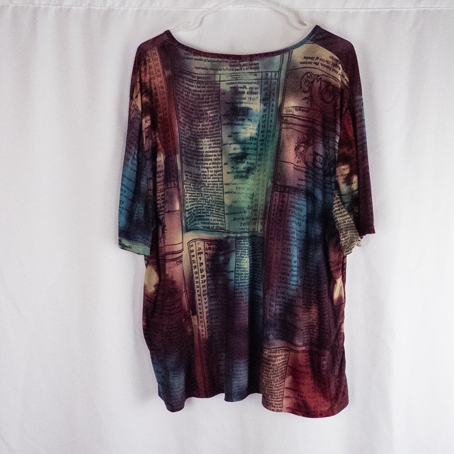 Nygard multicolor horoscope boho top with v-neck and short sleeves hanging on plastic hanger image 6