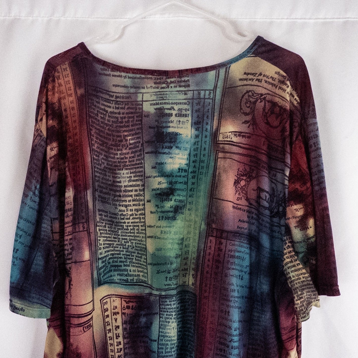 Nygard multicolor horoscope boho top with v-neck and short sleeves hanging on plastic hanger image 7