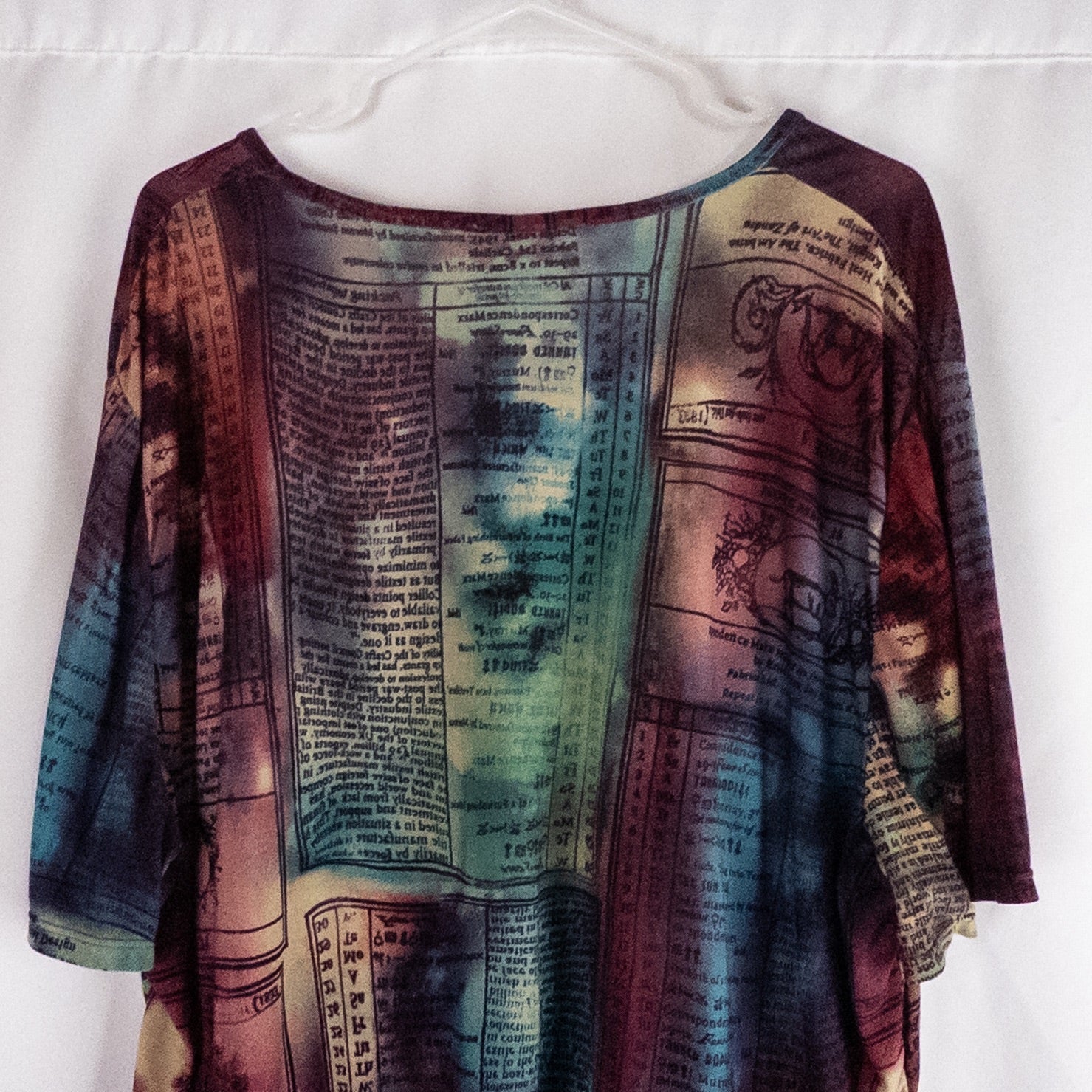 Nygard multicolor horoscope boho top with v-neck and short sleeves hanging on plastic hanger image 7
