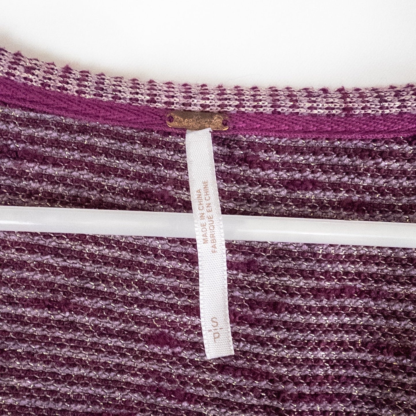 Free People knit purple and gold short puff sleeve sweater top on hanger against white background image 7