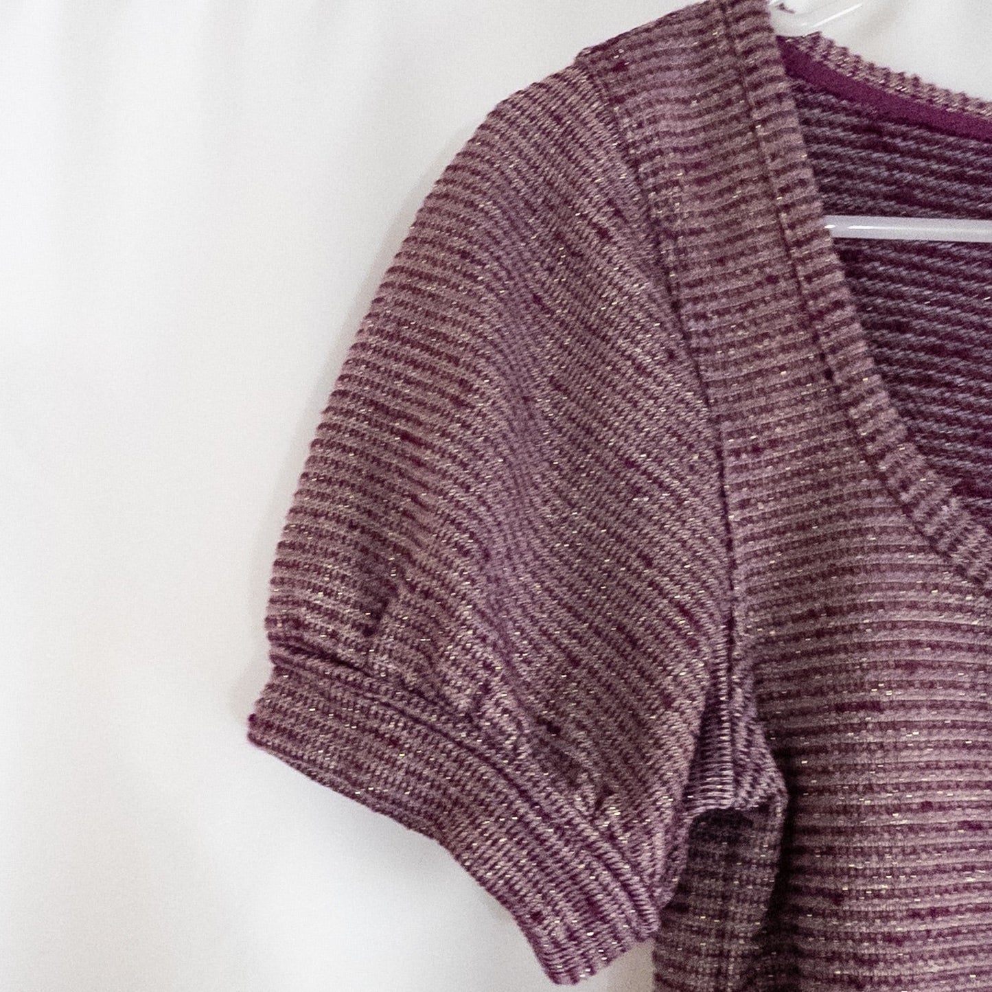 Free People knit purple and gold short puff sleeve sweater top on hanger against white background image 3