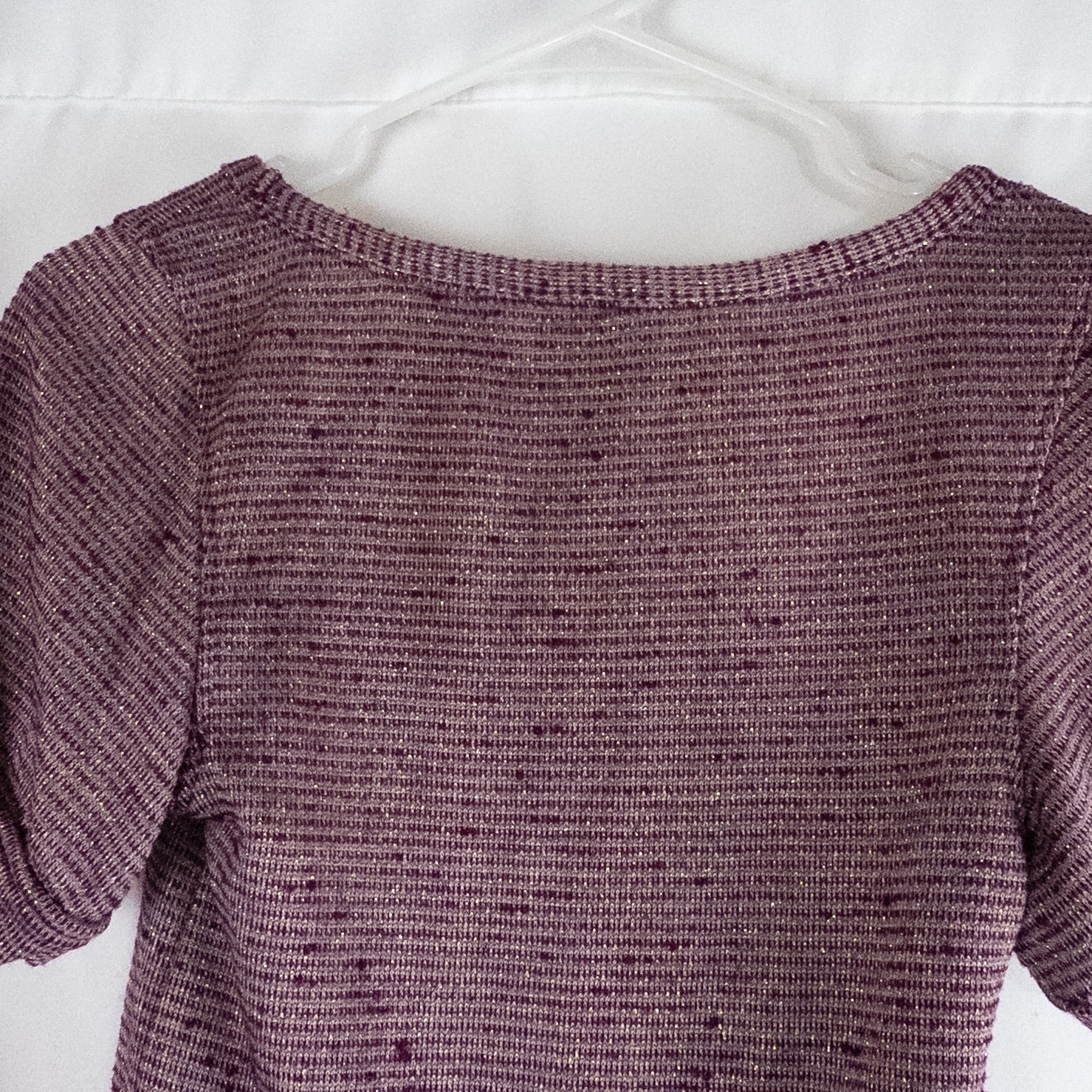 Free People knit purple and gold short puff sleeve sweater top on hanger against white background image 6