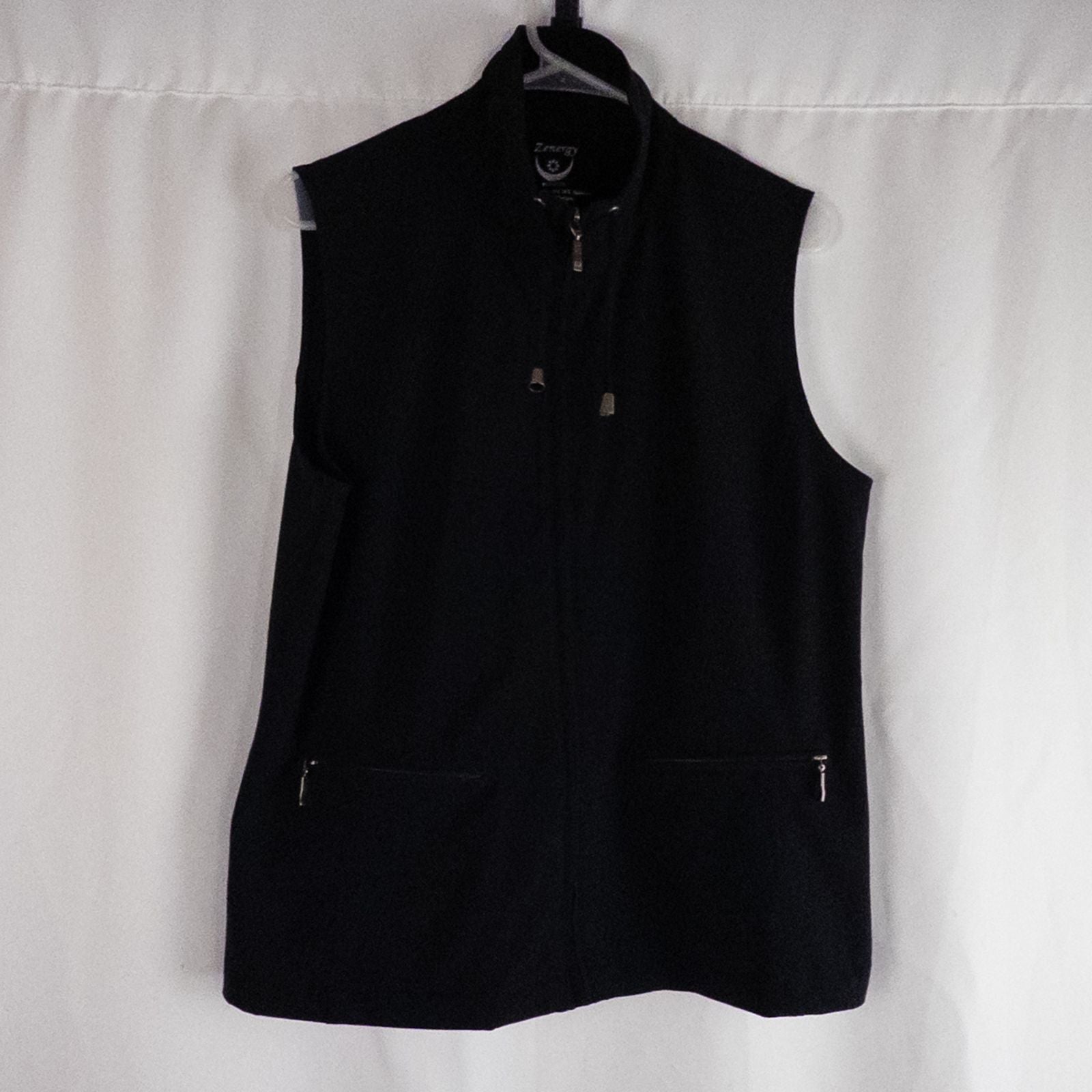 Chicos Zenergy black utility vest womens size 2 displayed on hanger showing front, back, collar, and smudge detail image 2