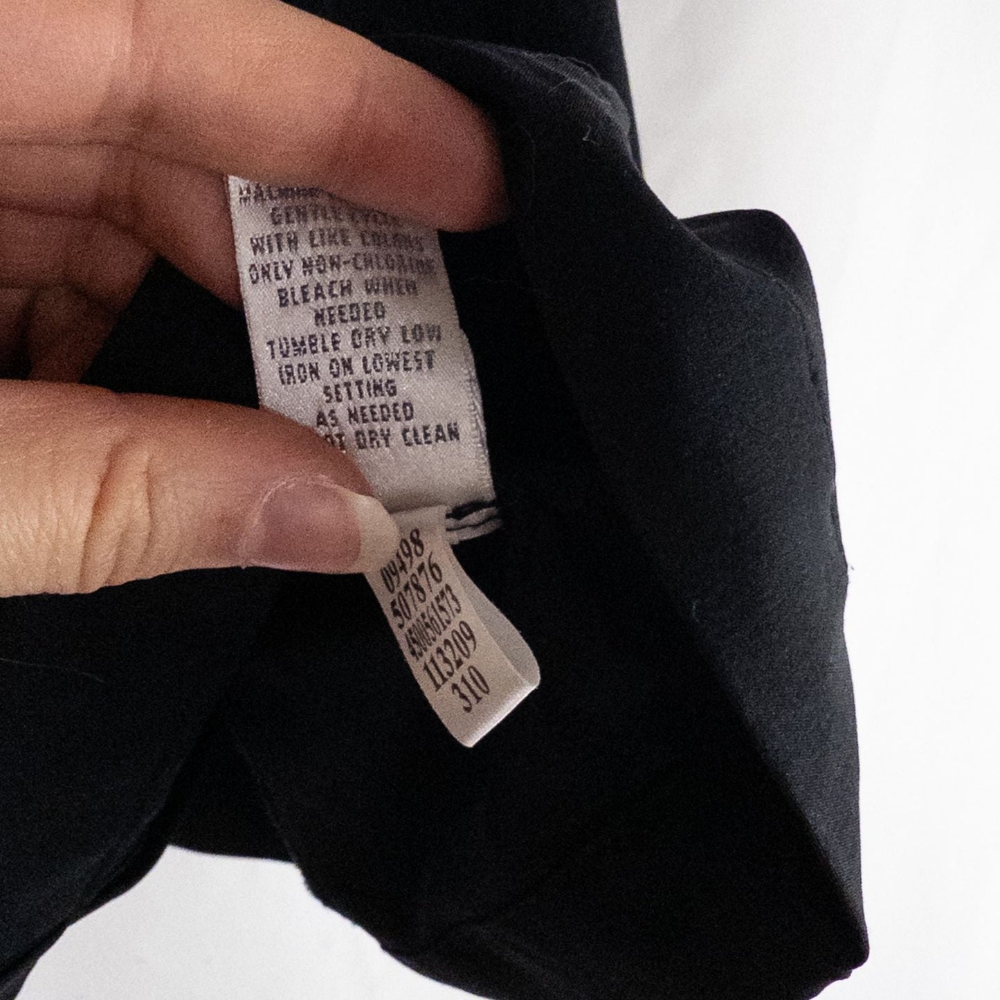 Chicos Zenergy black utility vest womens size 2 displayed on hanger showing front, back, collar, and smudge detail image 10
