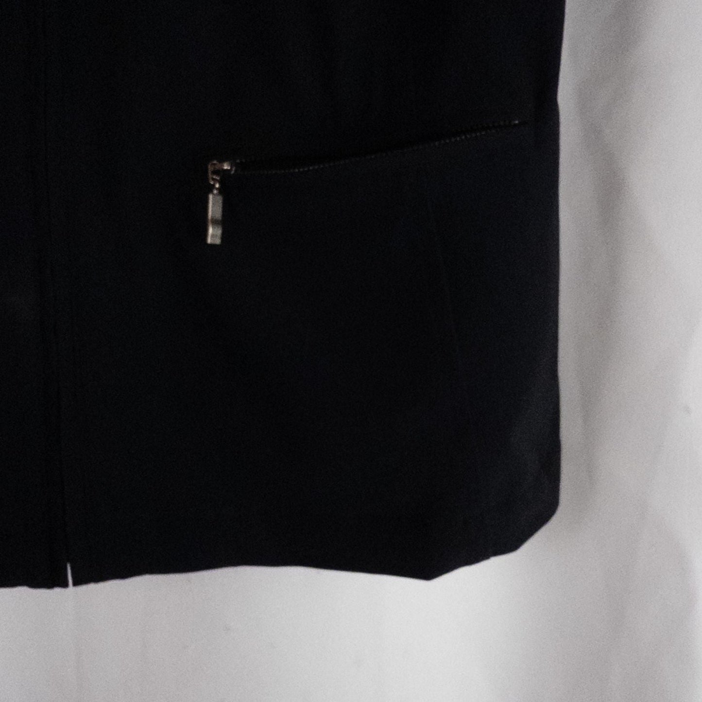Chicos Zenergy black utility vest womens size 2 displayed on hanger showing front, back, collar, and smudge detail image 3