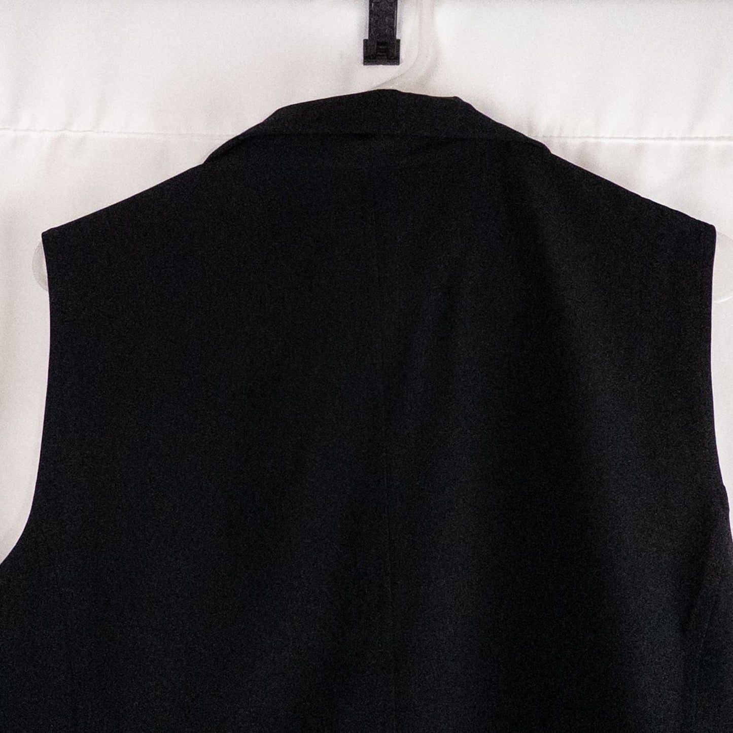 Chicos Zenergy black utility vest womens size 2 displayed on hanger showing front, back, collar, and smudge detail image 6