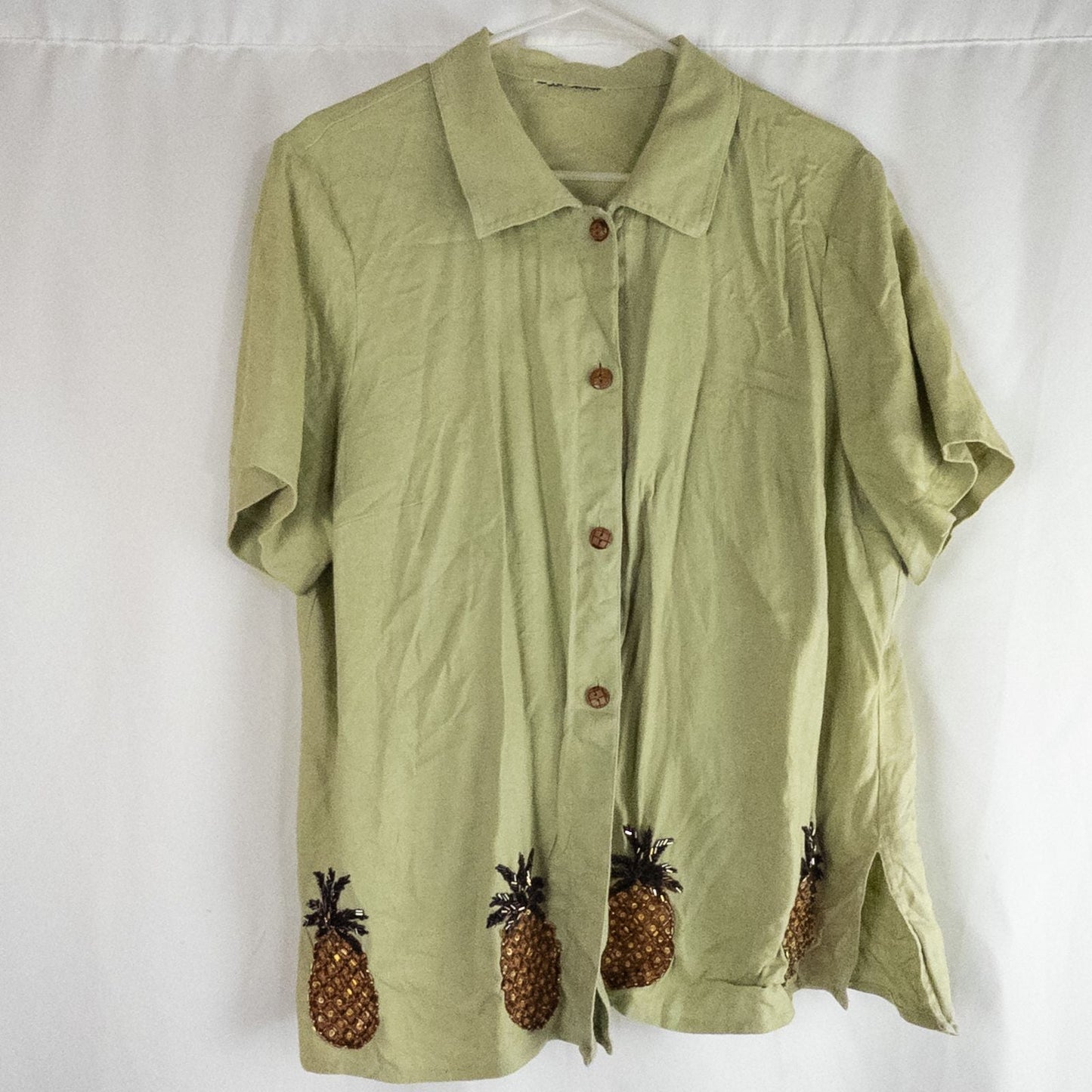 Vintage beaded pineapple linen short sleeve shirt in muted green with wooden buttons and detailed beadwork on pineapples