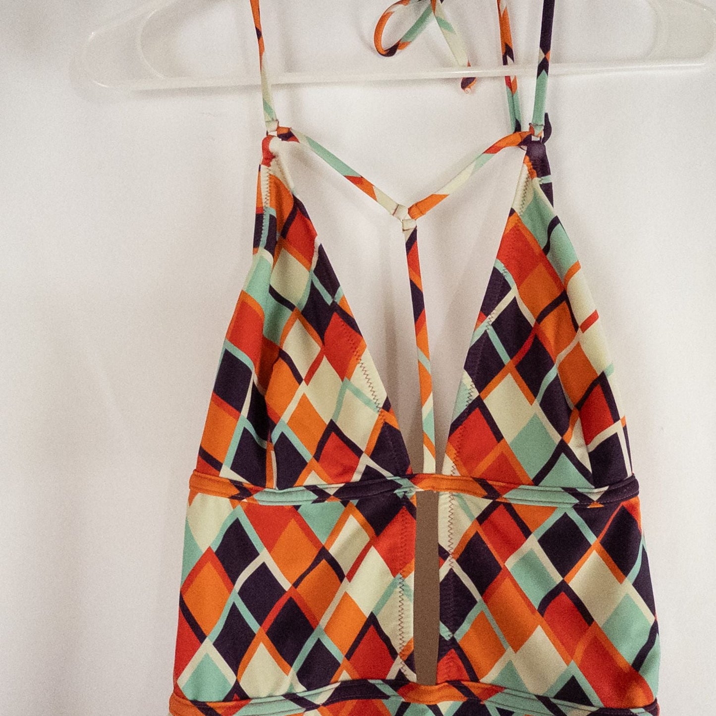 Orange teal geometric diamond pattern Cupshe one-piece swimsuit with halter neck and cutout detail shown hanging on white hanger image 2