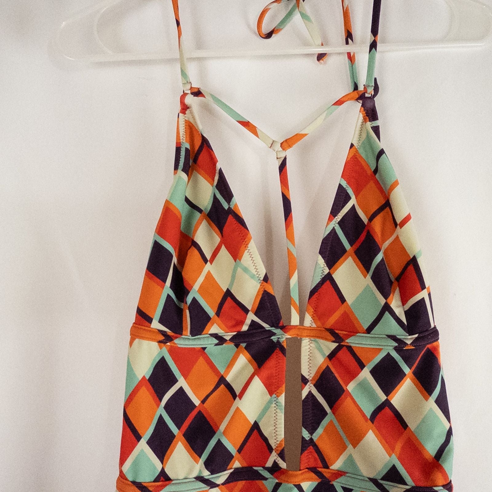 Orange teal geometric diamond pattern Cupshe one-piece swimsuit with halter neck and cutout detail shown hanging on white hanger image 2