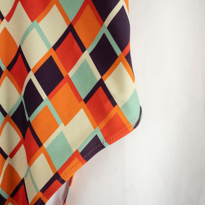 Orange teal geometric diamond pattern Cupshe one-piece swimsuit with halter neck and cutout detail shown hanging on white hanger image 7