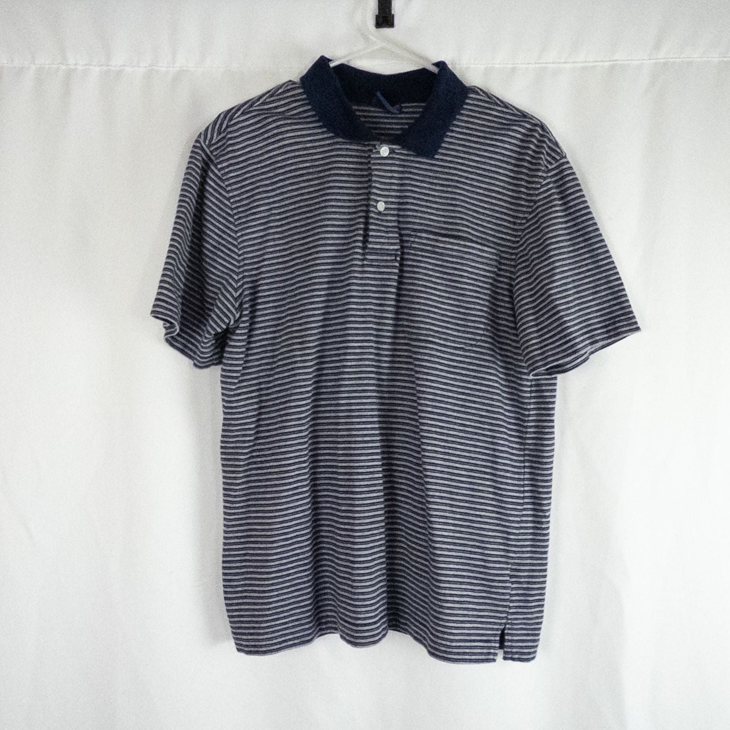 Puritan vintage men's medium blue gray striped polo shirt with collar and button closure hanging on a hanger front and back views