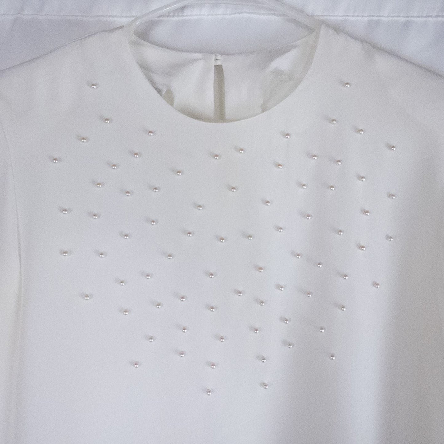 Anne Kriste vintage white sheer blouse with pearl beading on front and long sleeves with button cuffs hanging on hanger image 2