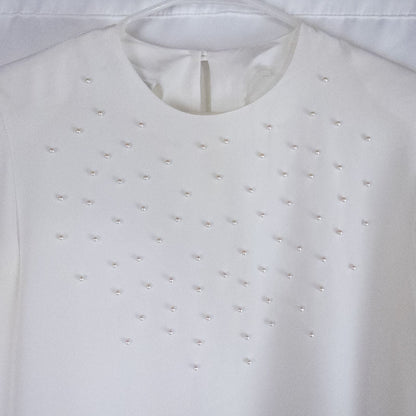 Anne Kriste vintage white sheer blouse with pearl beading on front and long sleeves with button cuffs hanging on hanger image 2