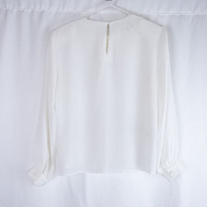 Anne Kriste vintage white sheer blouse with pearl beading on front and long sleeves with button cuffs hanging on hanger image 5
