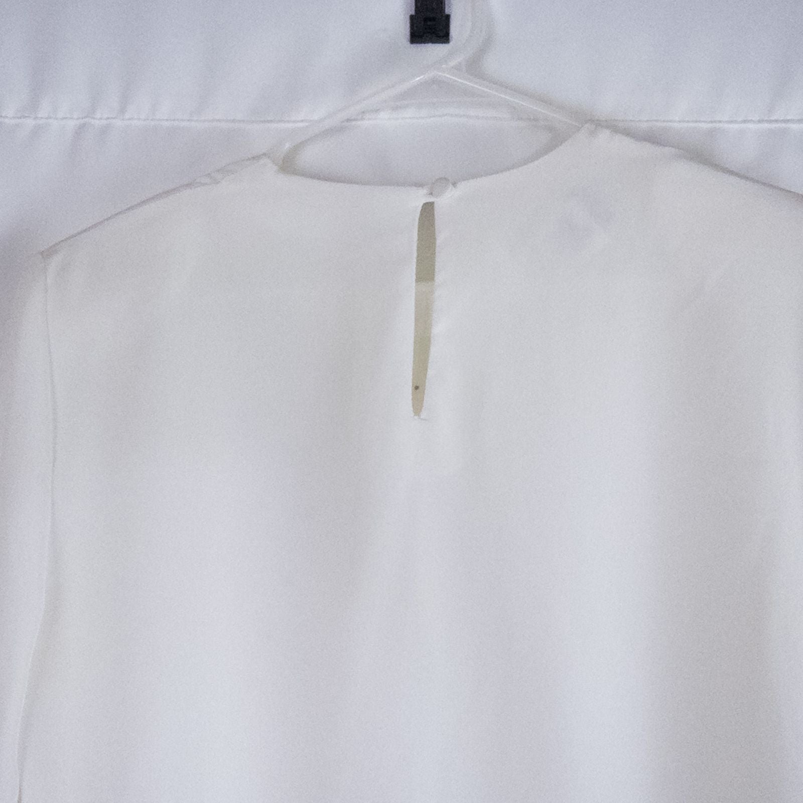 Anne Kriste vintage white sheer blouse with pearl beading on front and long sleeves with button cuffs hanging on hanger image 6