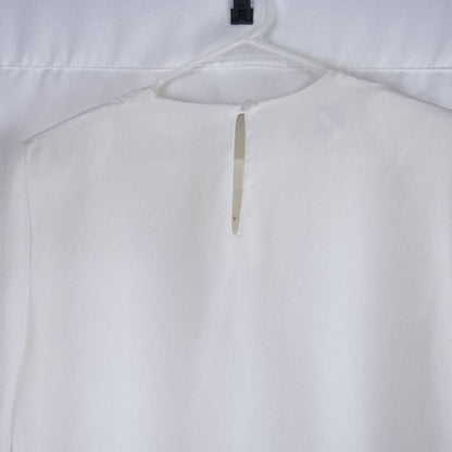 Anne Kriste vintage white sheer blouse with pearl beading on front and long sleeves with button cuffs hanging on hanger image 6
