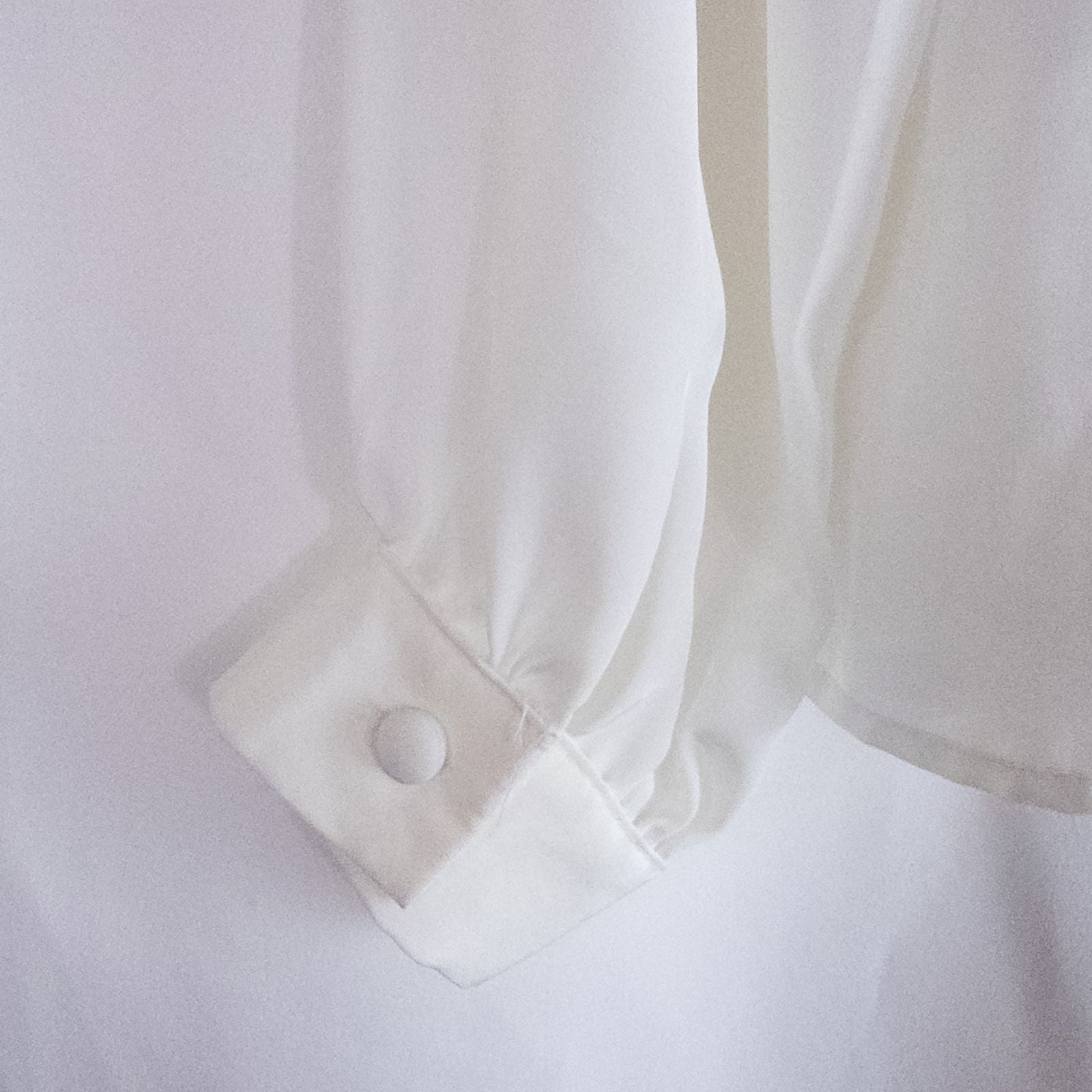 Anne Kriste vintage white sheer blouse with pearl beading on front and long sleeves with button cuffs hanging on hanger image 7