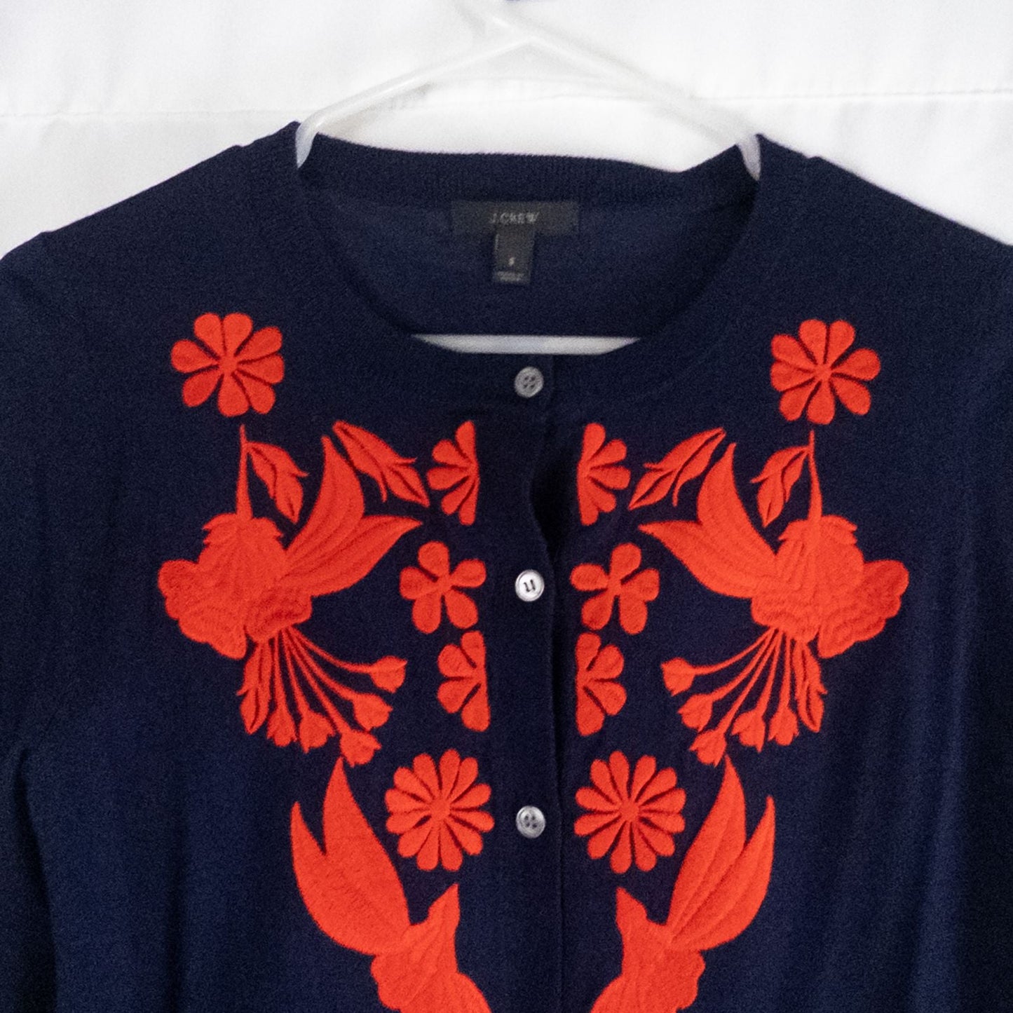 J Crew navy blue cardigan sweater with red embroidered floral design on front, button closure, long sleeves, and crew neck. image 2