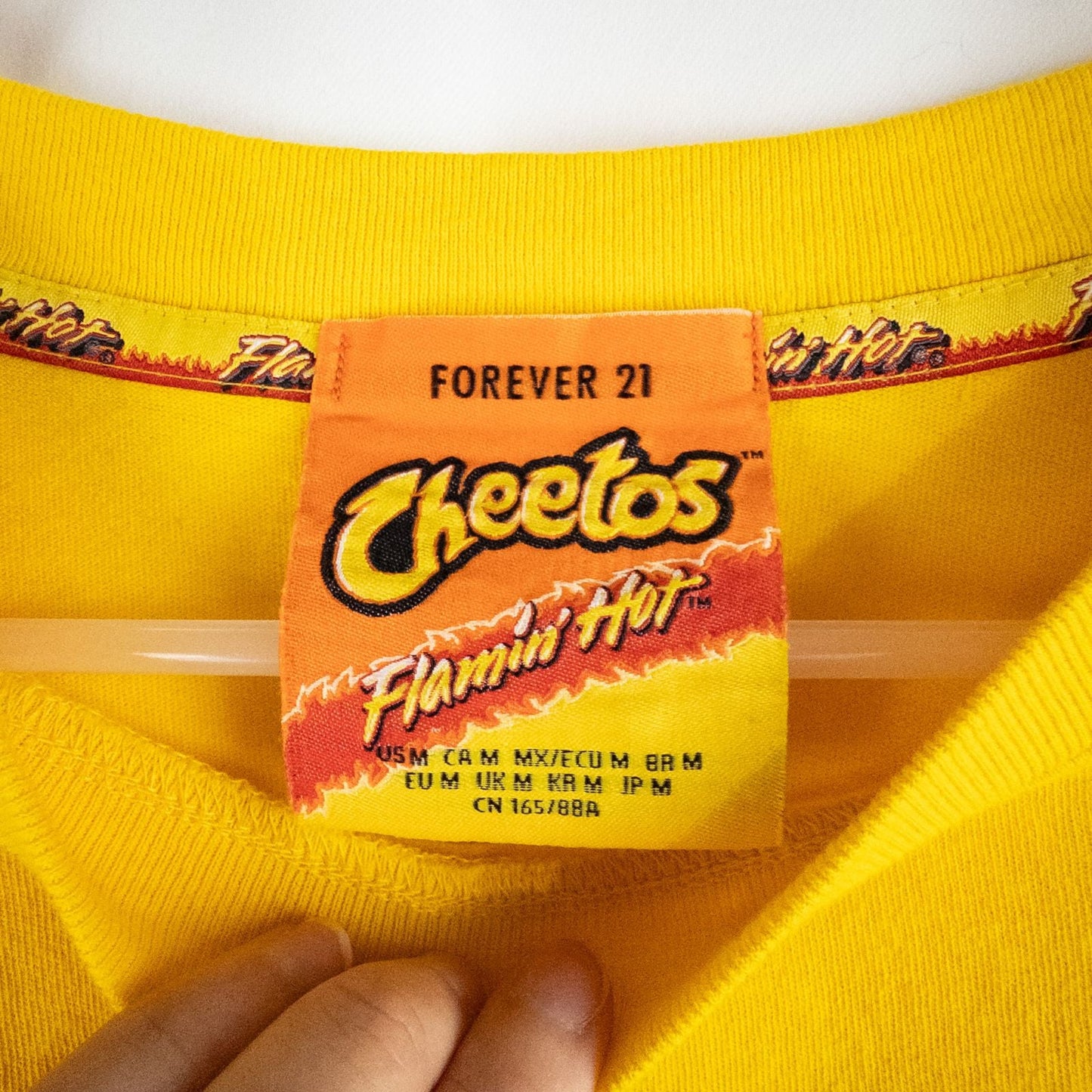 Yellow long sleeve shirt with Cheetos flame-breathing mascot graphic on front and flaming hot text on back image 10