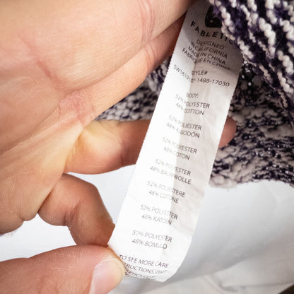 Purple and white striped open knit Fabletics sweater with textured yarn and relaxed oversized fit, shown front and close-up of knit texture and minor snags image 10