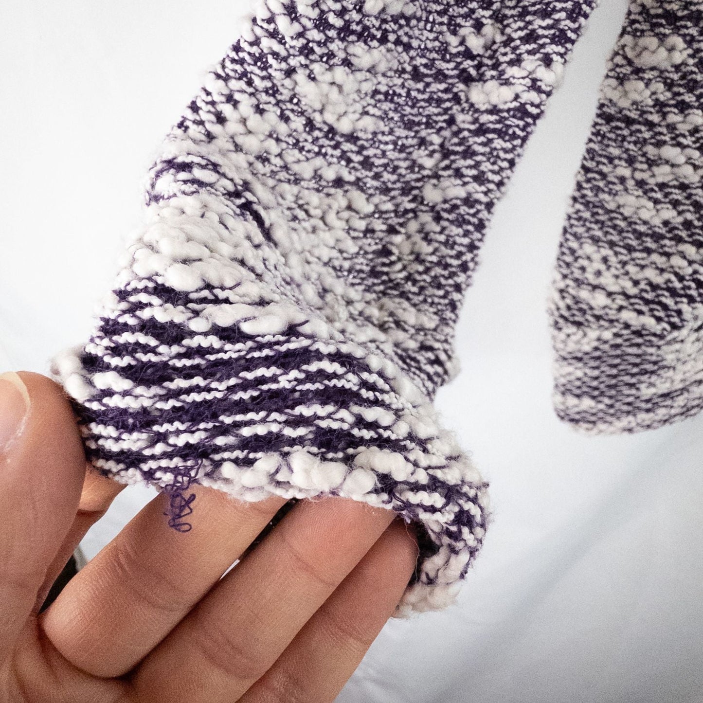 Purple and white striped open knit Fabletics sweater with textured yarn and relaxed oversized fit, shown front and close-up of knit texture and minor snags image 7
