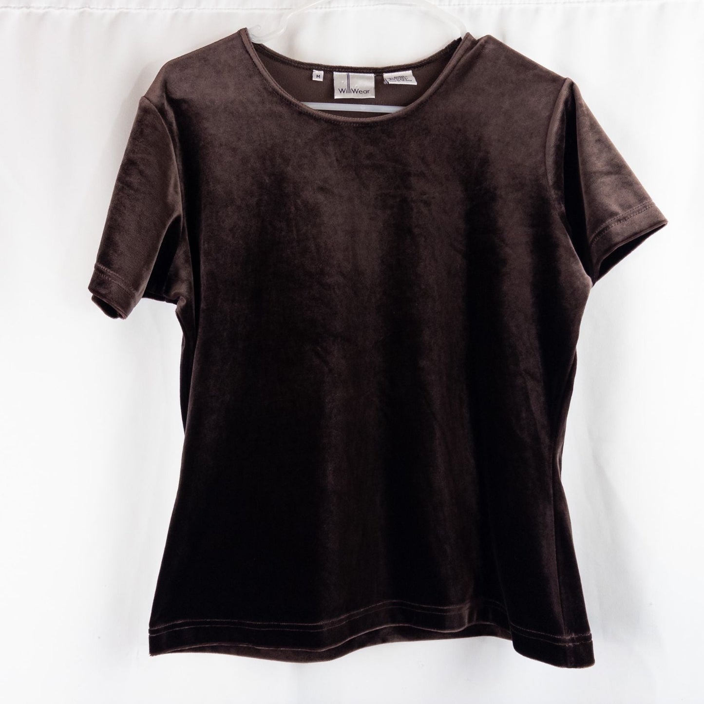Williwear vintage brown velvet top with short sleeves and crew neckline hanging on a hanger