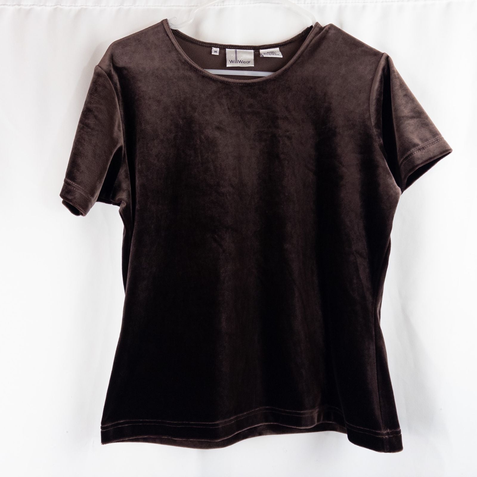 Williwear vintage brown velvet top with short sleeves and crew neckline hanging on a hanger