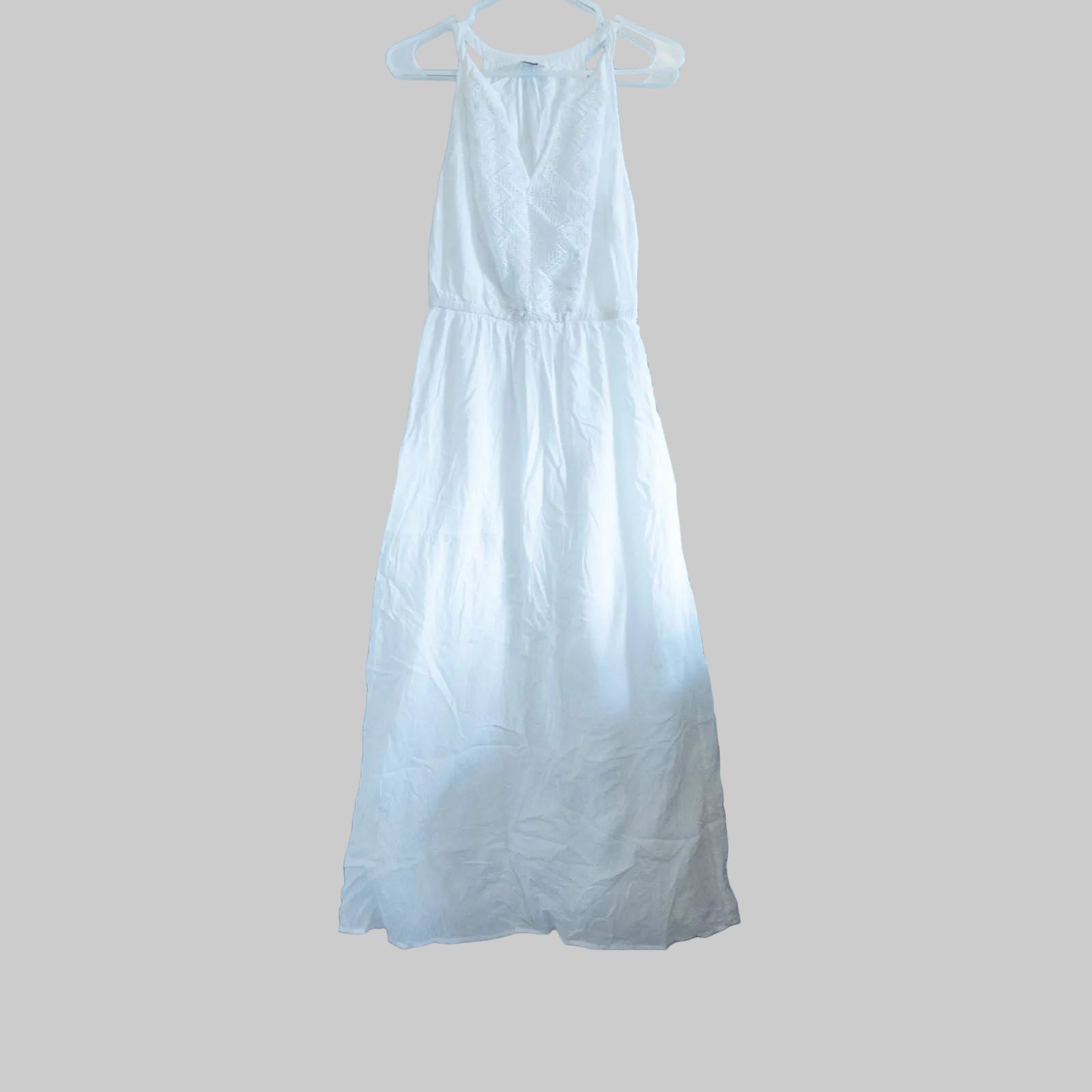 Old Navy long white sleeveless lace maxi dress hanging on hanger in room
