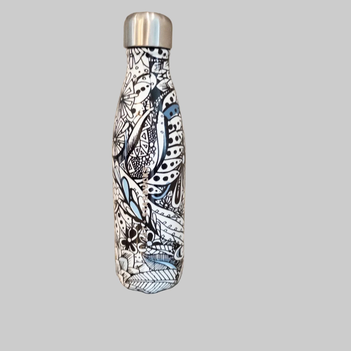 Starbucks Swizzle bottle with black white and blue artistic floral abstract print on countertop