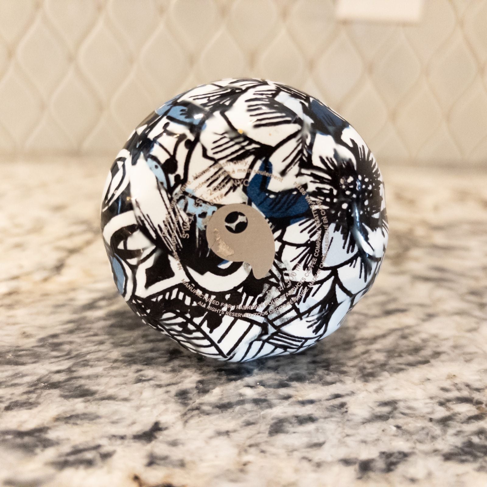 Starbucks Swizzle bottle with black white and blue artistic floral abstract print on countertop image 13