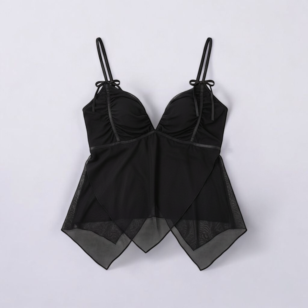 Black Shaye tank top with ruched bust and layered sheer chiffon overlay on a model and hanging on a hanger front on white muslin photography backdrop