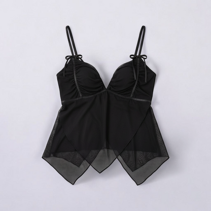 Black Shaye tank top with ruched bust and layered sheer chiffon overlay on a model and hanging on a hanger front on white muslin photography backdrop