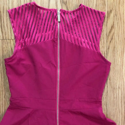 Pink sleeveless dress with sheer striped mesh panels on neckline and hem laid flat on wood floor image 6